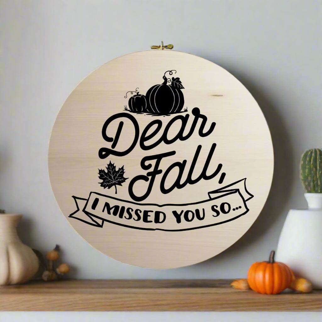 Round wooden ornament with 'Dear Fall, I missed you so...' text and pumpkins on a white background