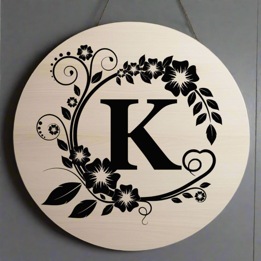 Decorative circular design with the letter 'K' surrounded by floral elements on a beige background.