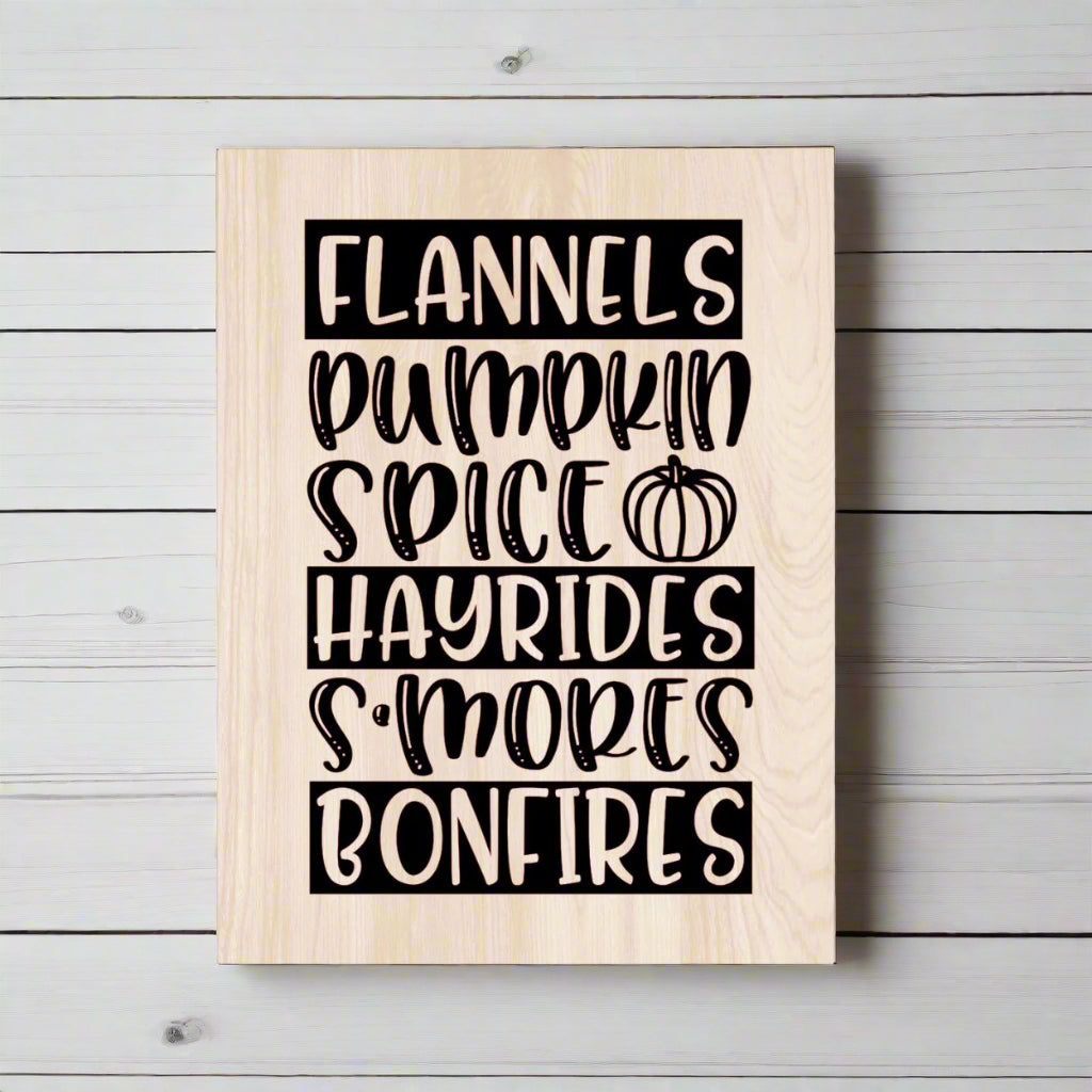 Wooden sign with black text listing fall activities on a white background