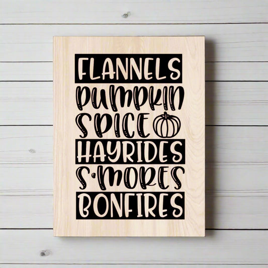 Wooden sign with black text listing fall activities on a white background
